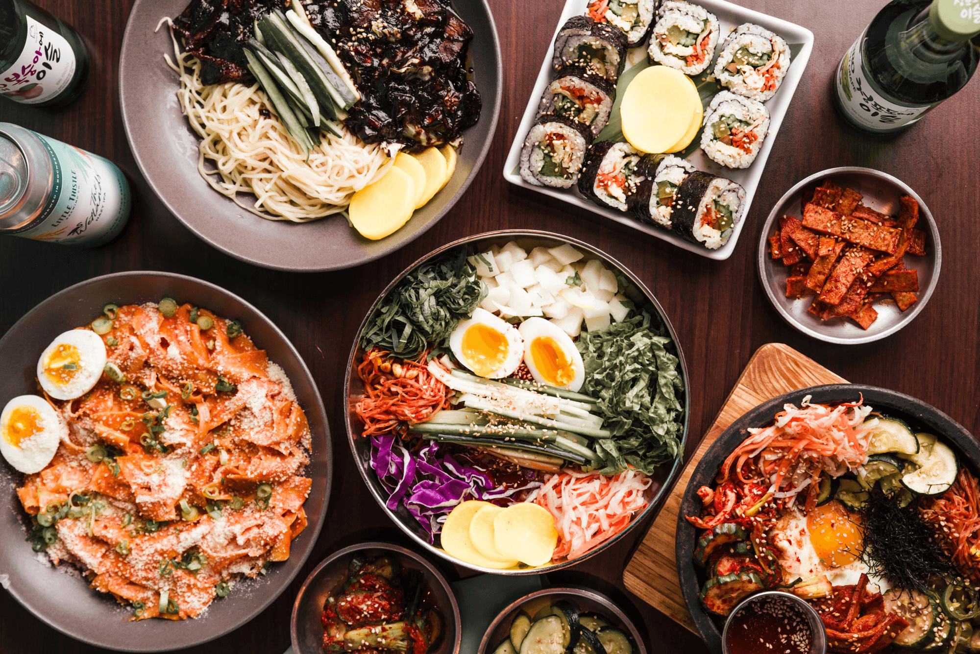 Spread of Korean dishes including bibimbap, kimbap, and noodles at Bebap