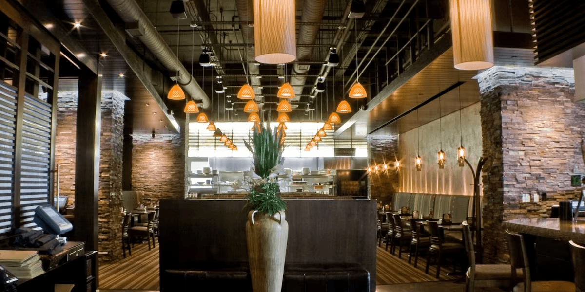 Chesters dining room with stone columns and pendant lighting