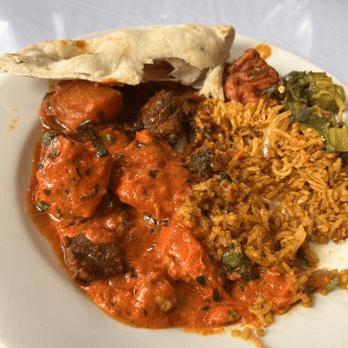 Plate of butter chicken, rice, and naan from India Garden